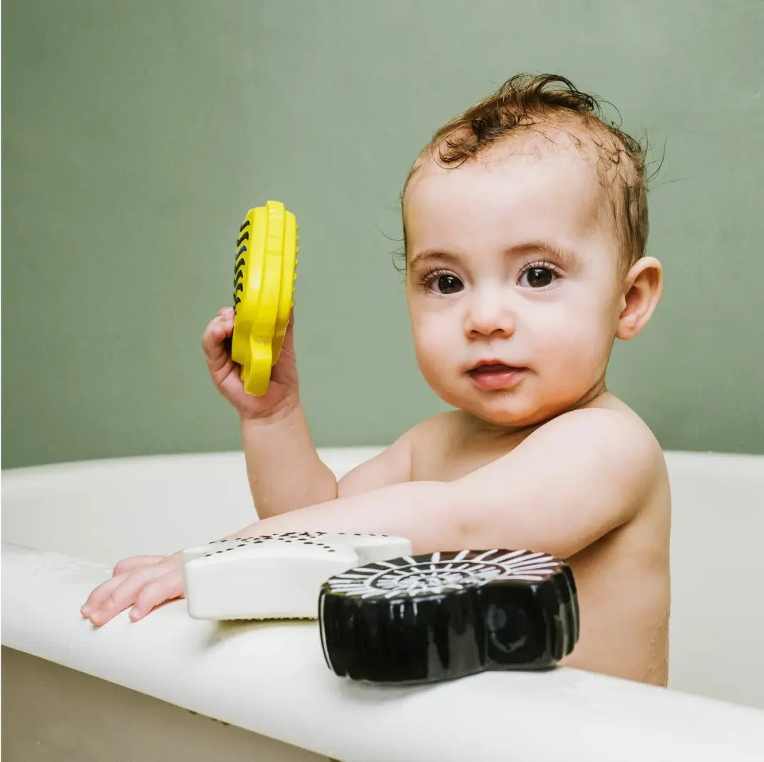 A young baby in the bath with Etta loves baby sensory bath toys