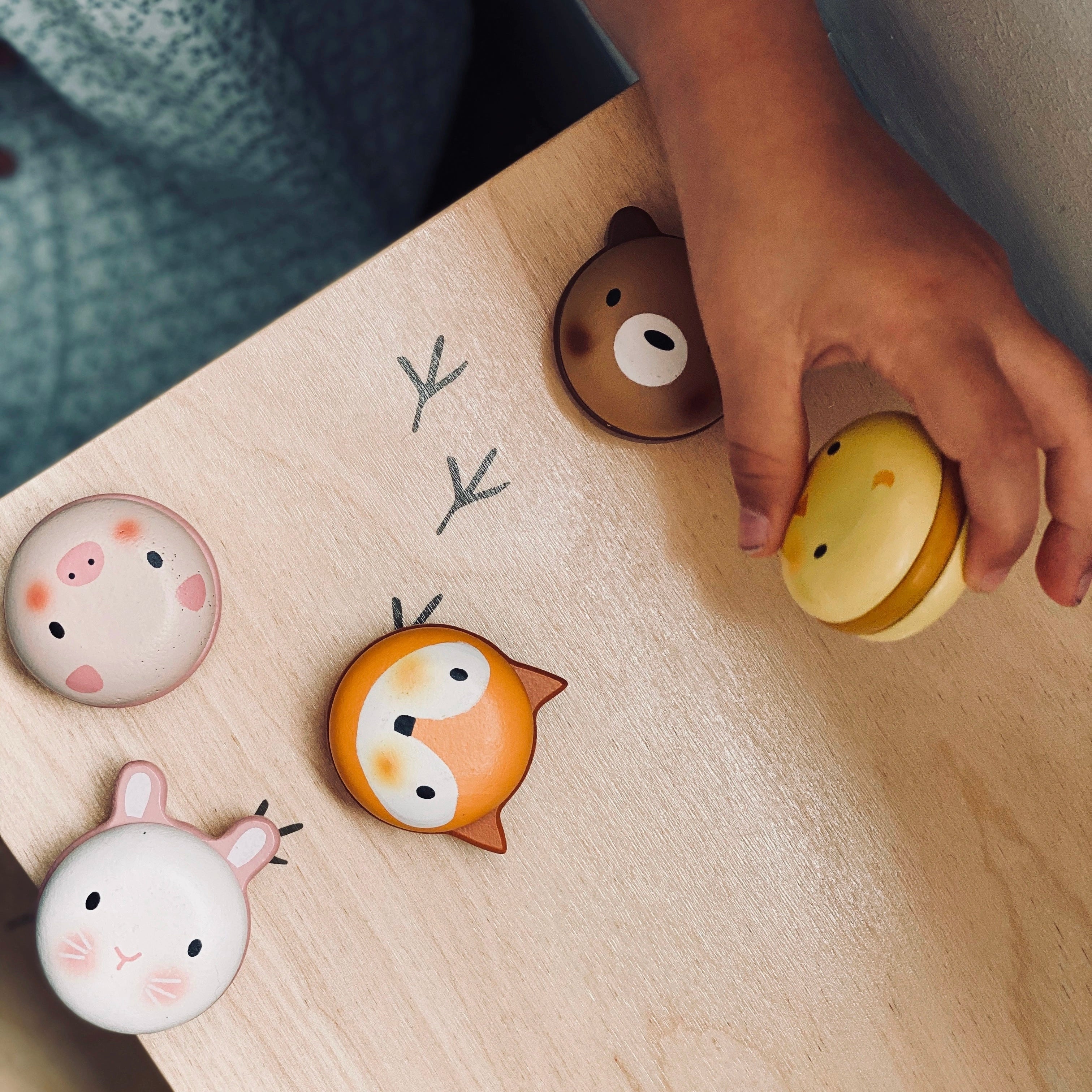 Colourful wooden animal themed macarons on a wooden board